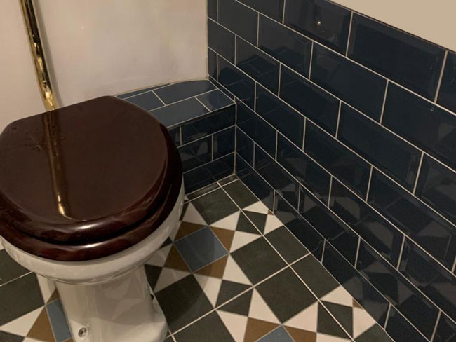 Victorian tiled bathroom floor and walls